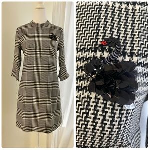 Black dress with swan brooch